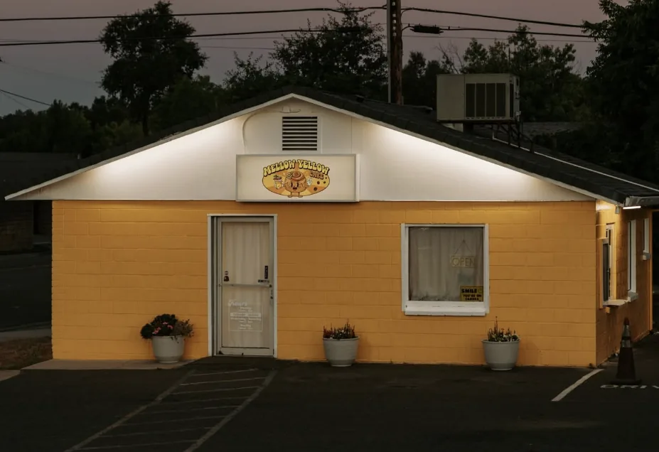 The Mellow Yellow Cafe storefront at dusk, sign lit above the door