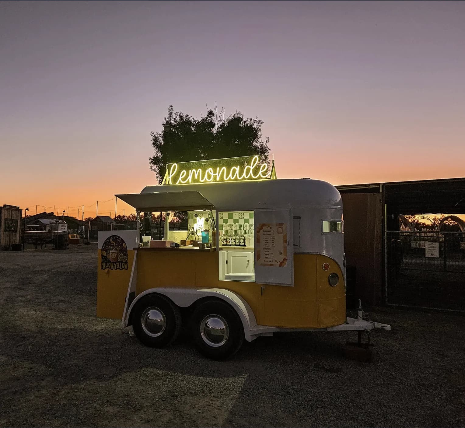 The original Mellow Yellow lemonade trailer at dusk, neon sign glowing